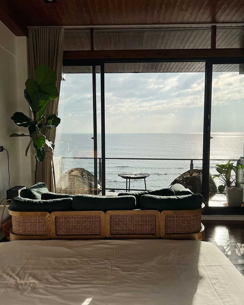 A hotel room opening onto the sea