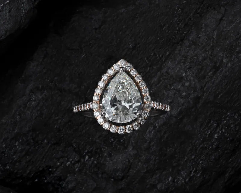 A teardrop diamond ring on dark stone