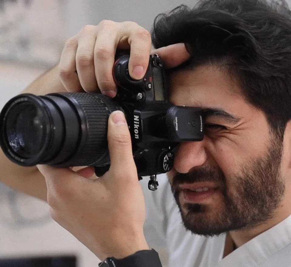 A dentist photographing a patient's smile with a camera