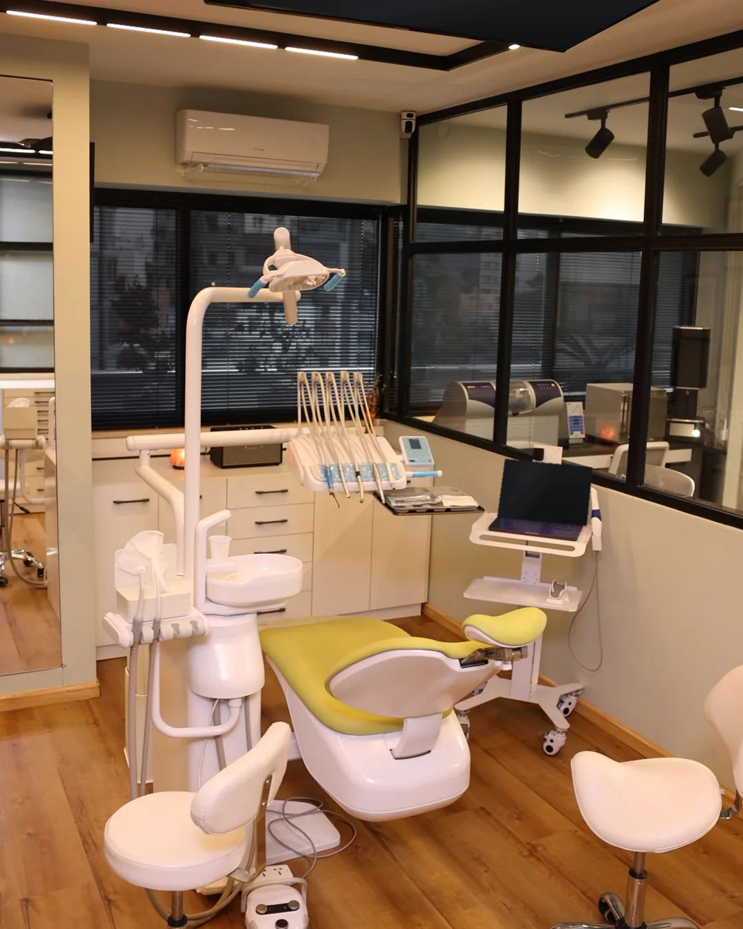 A treatment room at Mineers, with a lime-green chair and windows over Beirut