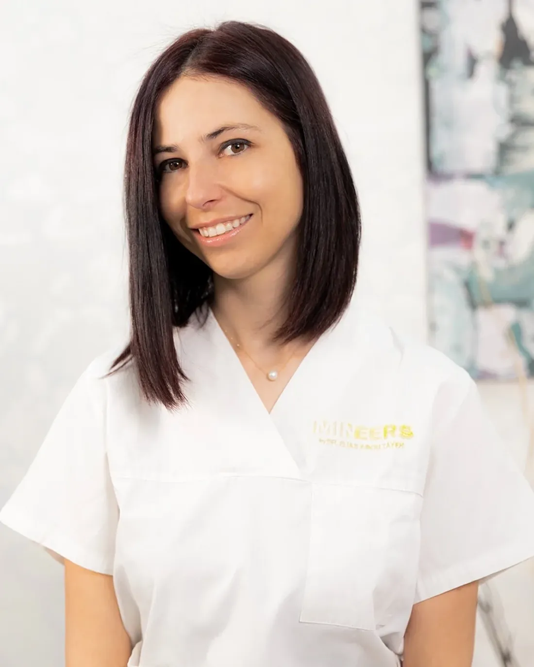Dr. Milena Ilieva, smiling, in a white Mineers top