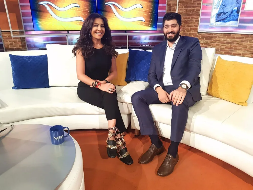 Dr. Elias Abou Tayeh with a presenter in a television studio