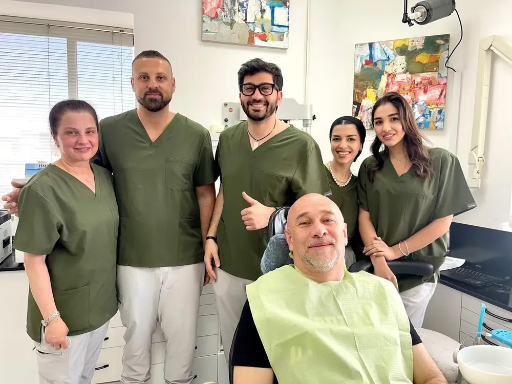 Dr. Elias Abou Tayeh and his team with a patient in the chair