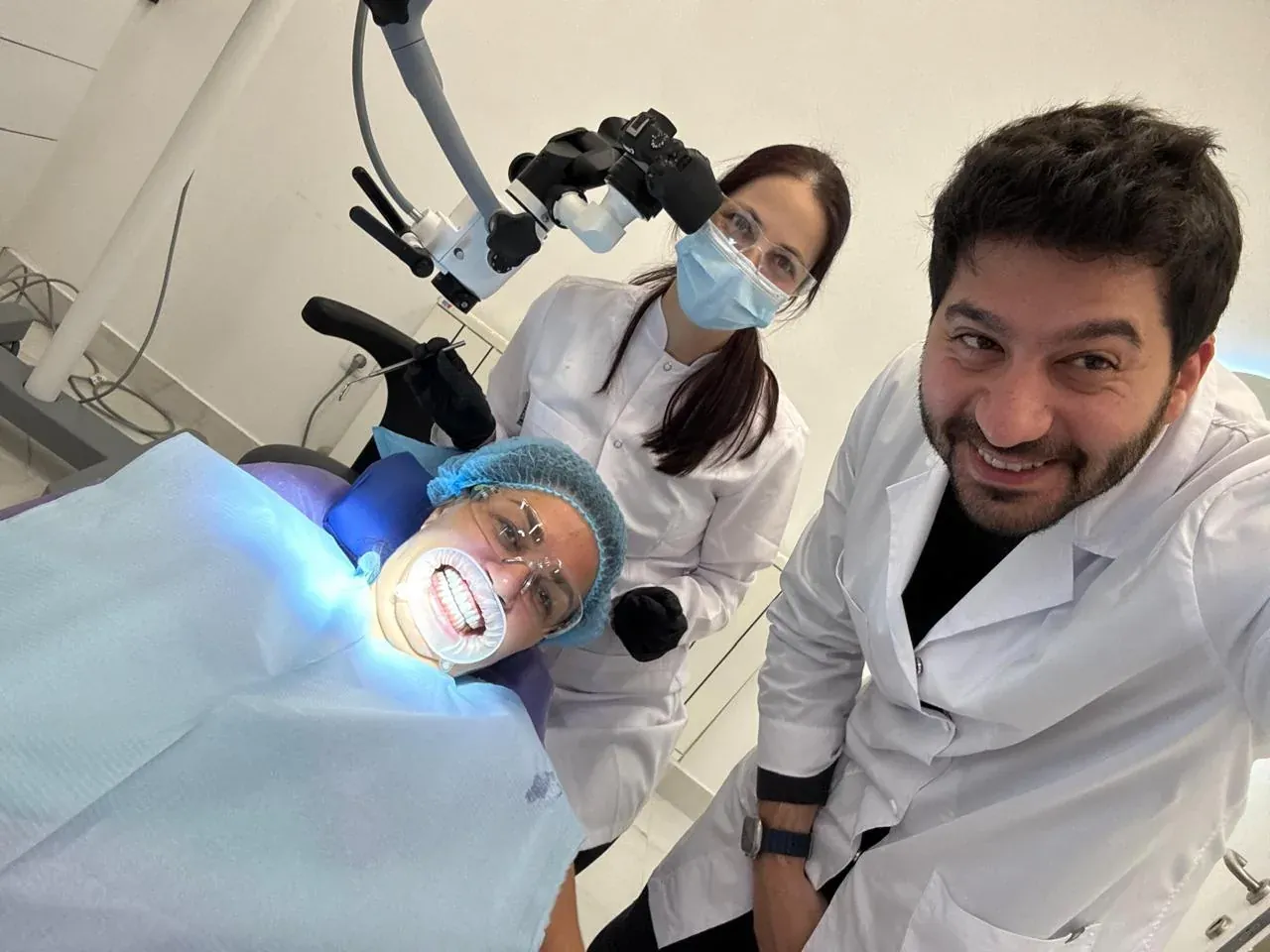 Dr. Elias Abou Tayeh and his assistant with a patient in the chair