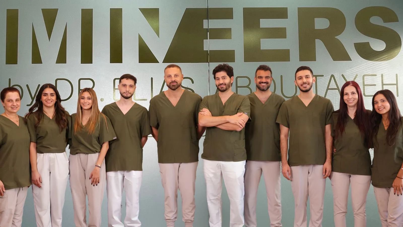 The Mineers team at the clinic, in front of the Mineers sign